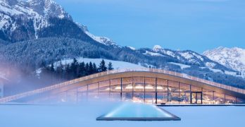 Snow covered ATMOSPHERE spa at Hotel Krallerhoff, with the Austrian Alps behind