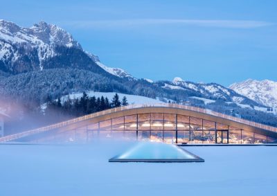 Snow covered ATMOSPHERE spa at Hotel Krallerhoff, with the Austrian Alps behind